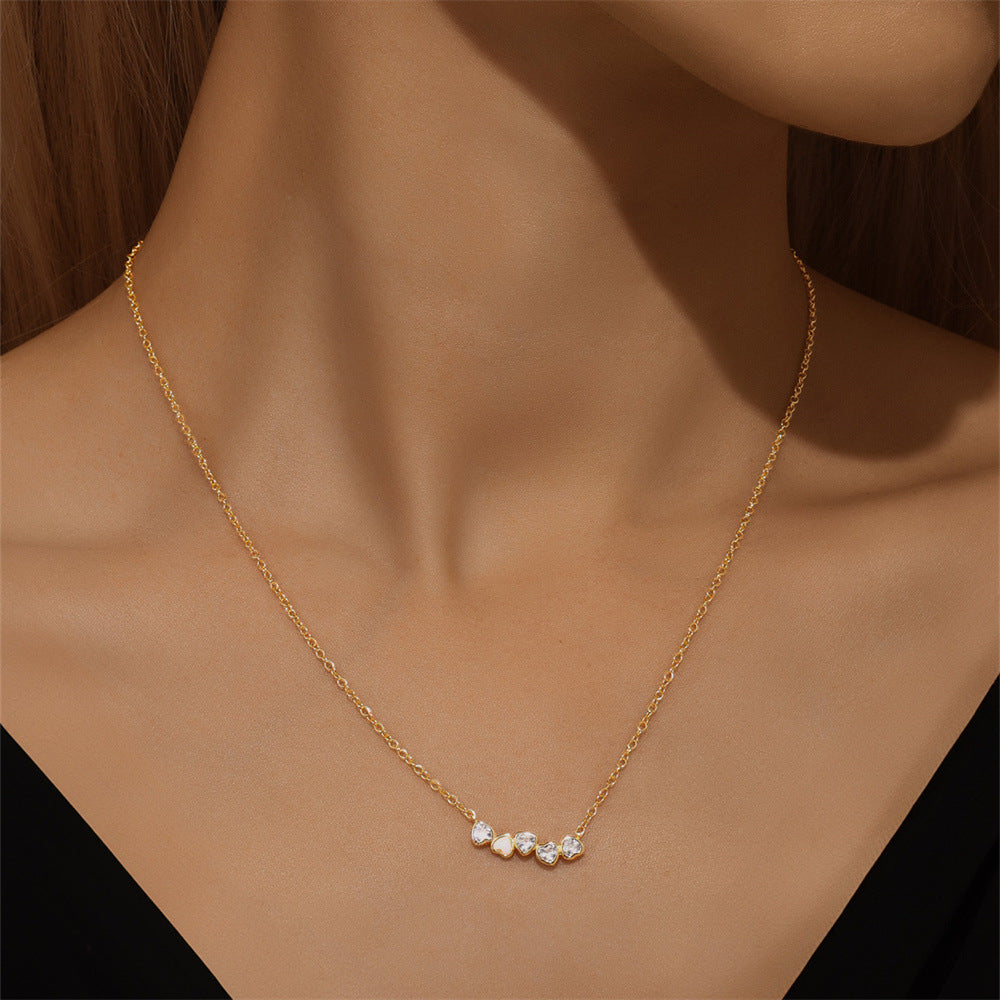 Dainty gold heart necklace with opal zircon details, a perfect jewelry piece for everyday elegance.