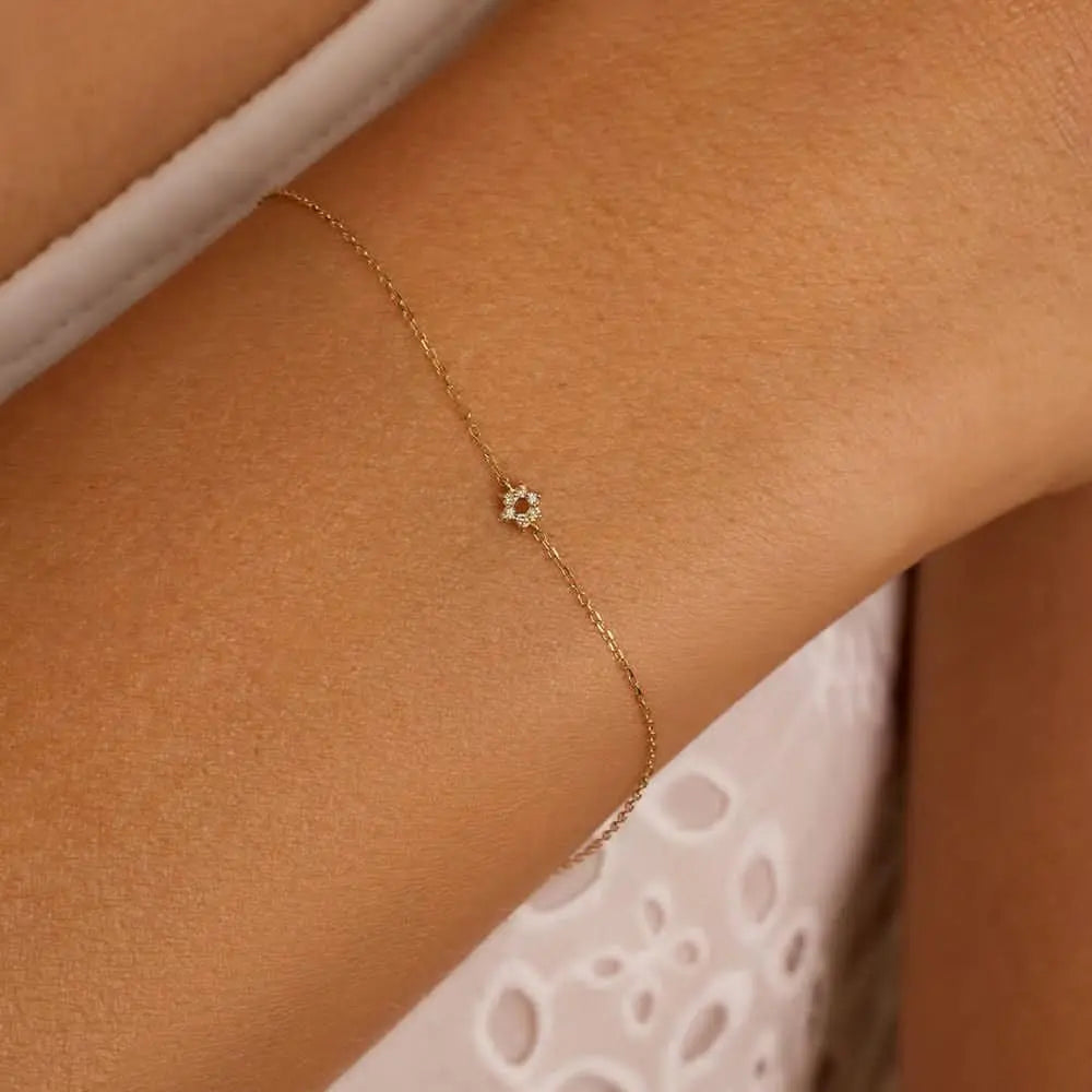 Delicate gold flower bracelet with minimalist design, perfect for everyday wear.