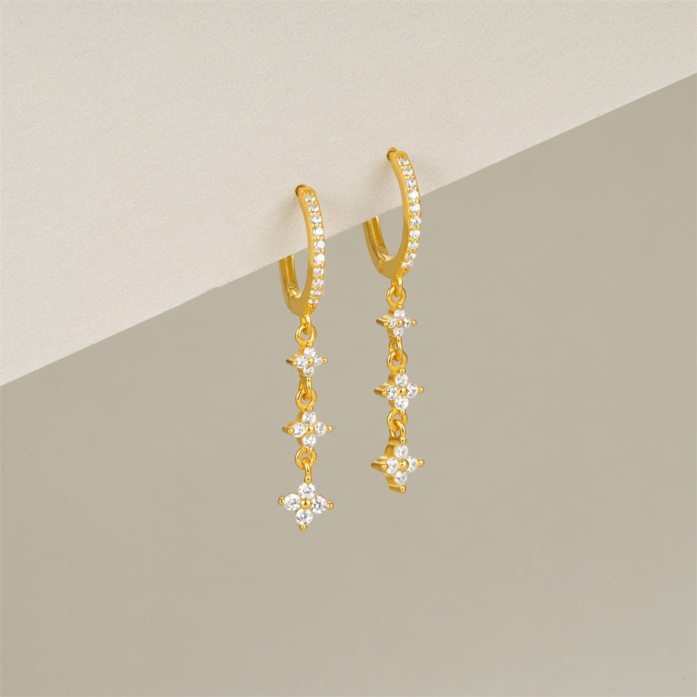 Diamond star dangle earrings, ideal for sensitive ears with a stunning gold design.
