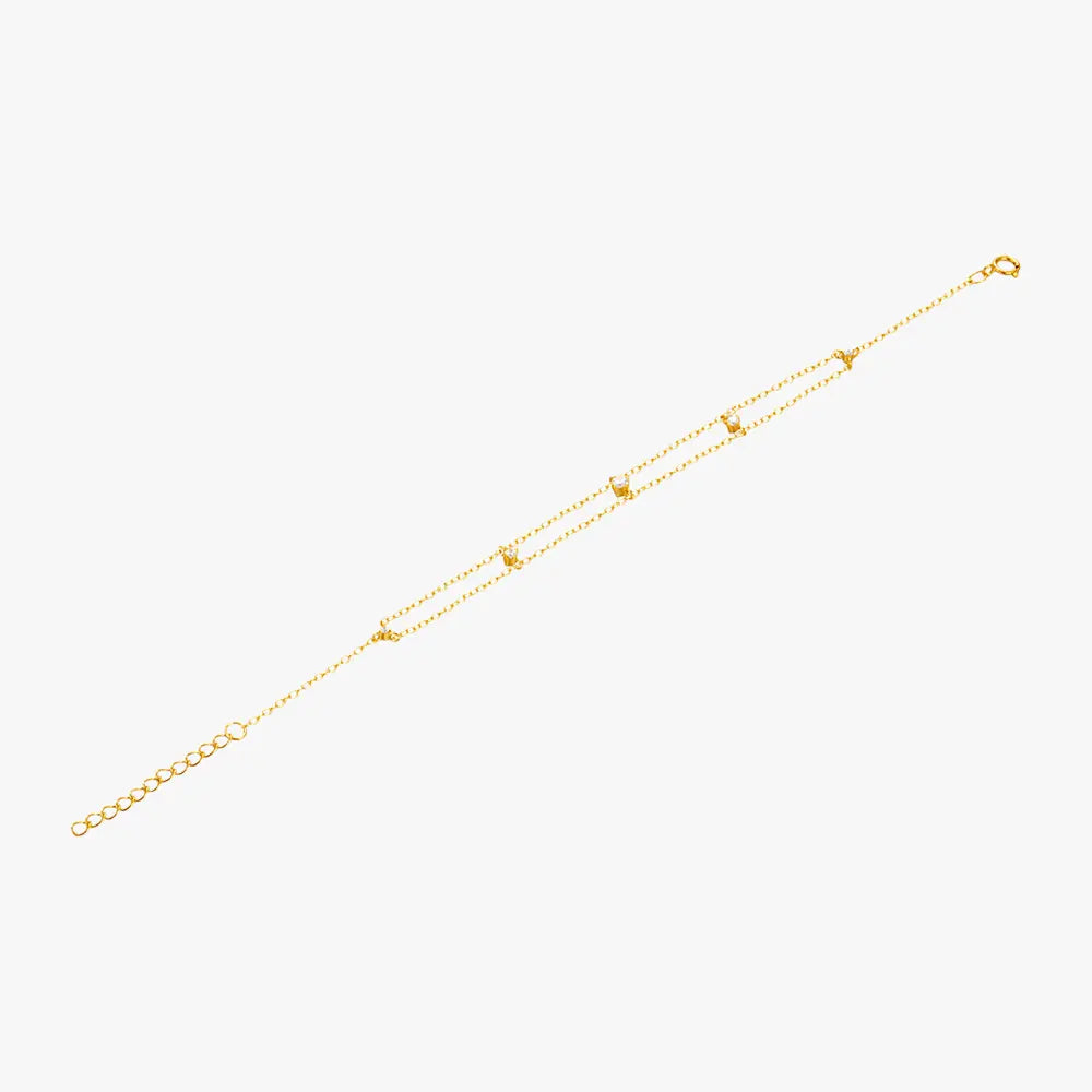 Elegant gold bracelet with layered chains and crystal details, perfect for a chic look.