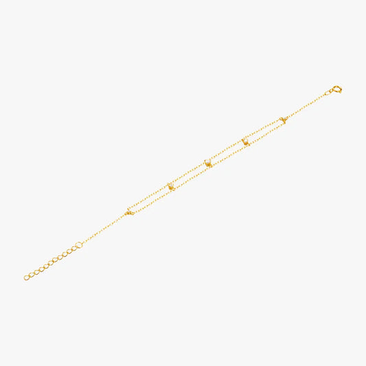 Elegant gold bracelet with layered chains and crystal details, perfect for a chic look.