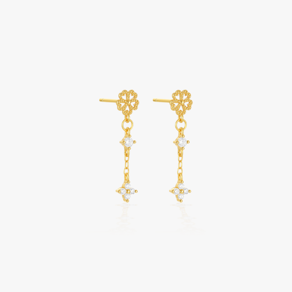 Elegant floral design gold earrings with diamond accents, ideal for enhancing a chic outfit.