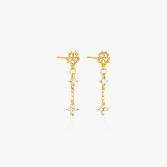 Elegant floral design gold earrings with diamond accents, ideal for enhancing a chic outfit.