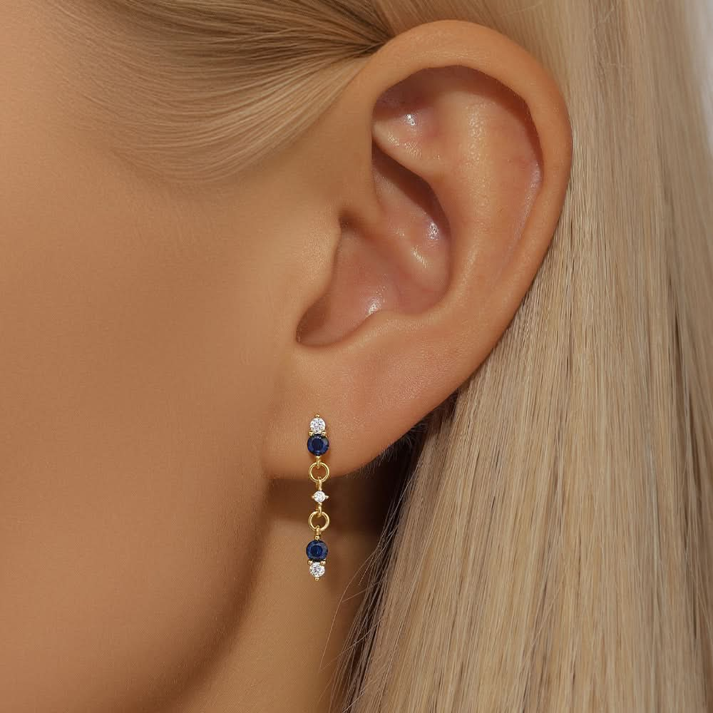 Beautiful gold-plated S925 sterling silver dangle earrings featuring blue gemstones.