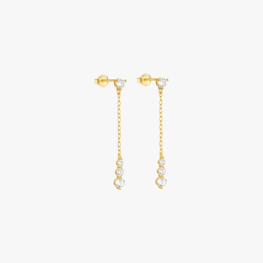 Gold dangle earrings with crystal embellishments on a delicate chain, perfect for adding sparkle and elegance to any outfit.