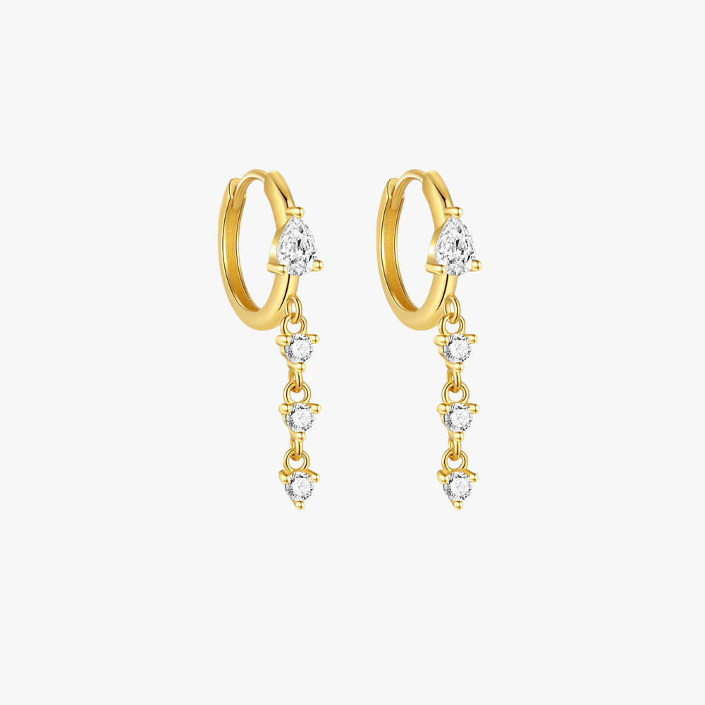 Elegant gold huggie hoop earrings with teardrop cubic zirconia dangles. A modern and stylish jewelry piece for any occasion.