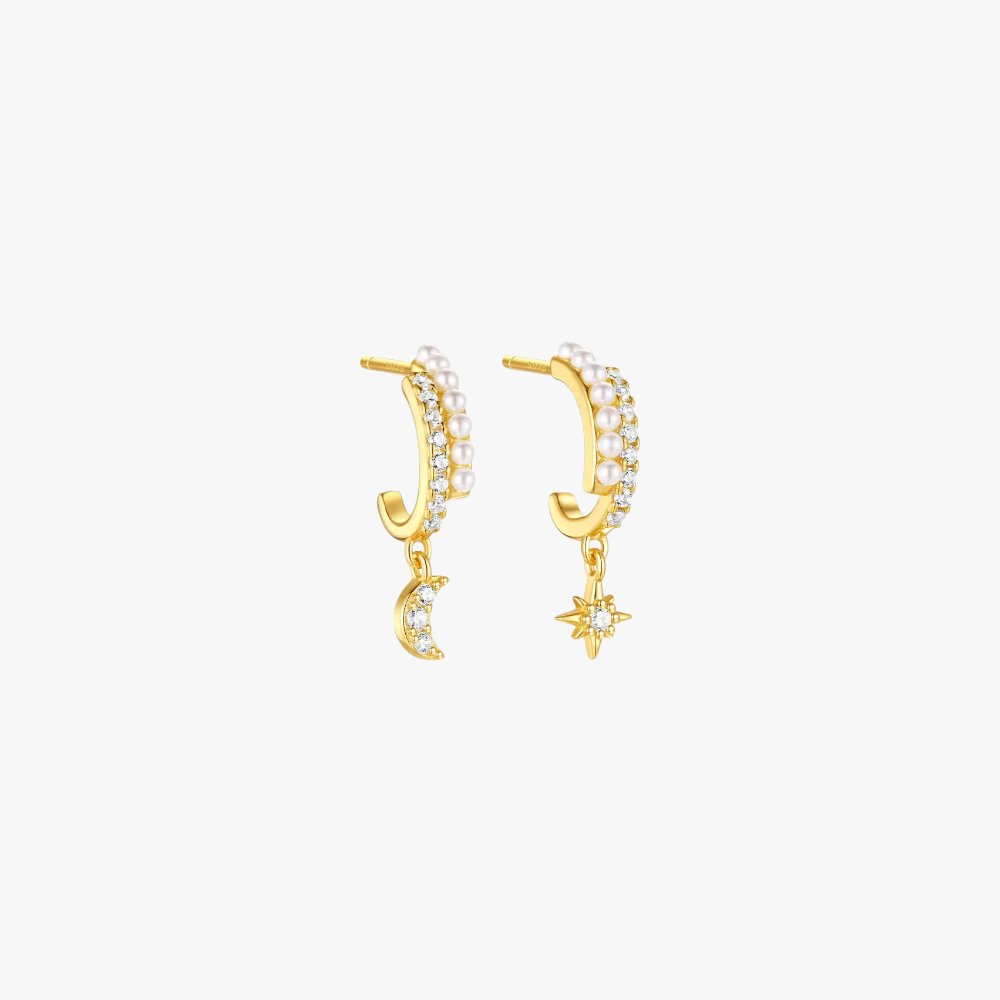 Gold moon and star earrings with pearl and crystal accents, celestial-inspired design.