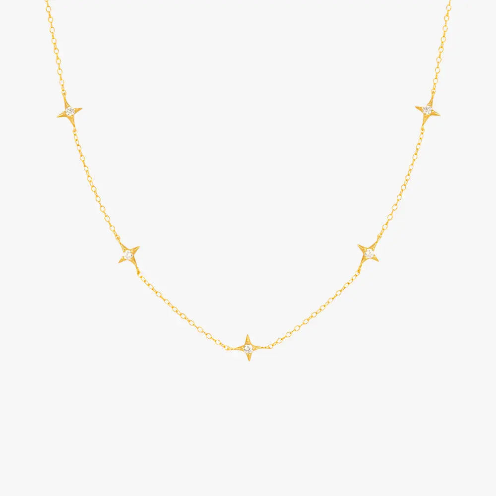 Gold necklace featuring multiple star pendants with diamonds, ideal for a celestial-inspired look.