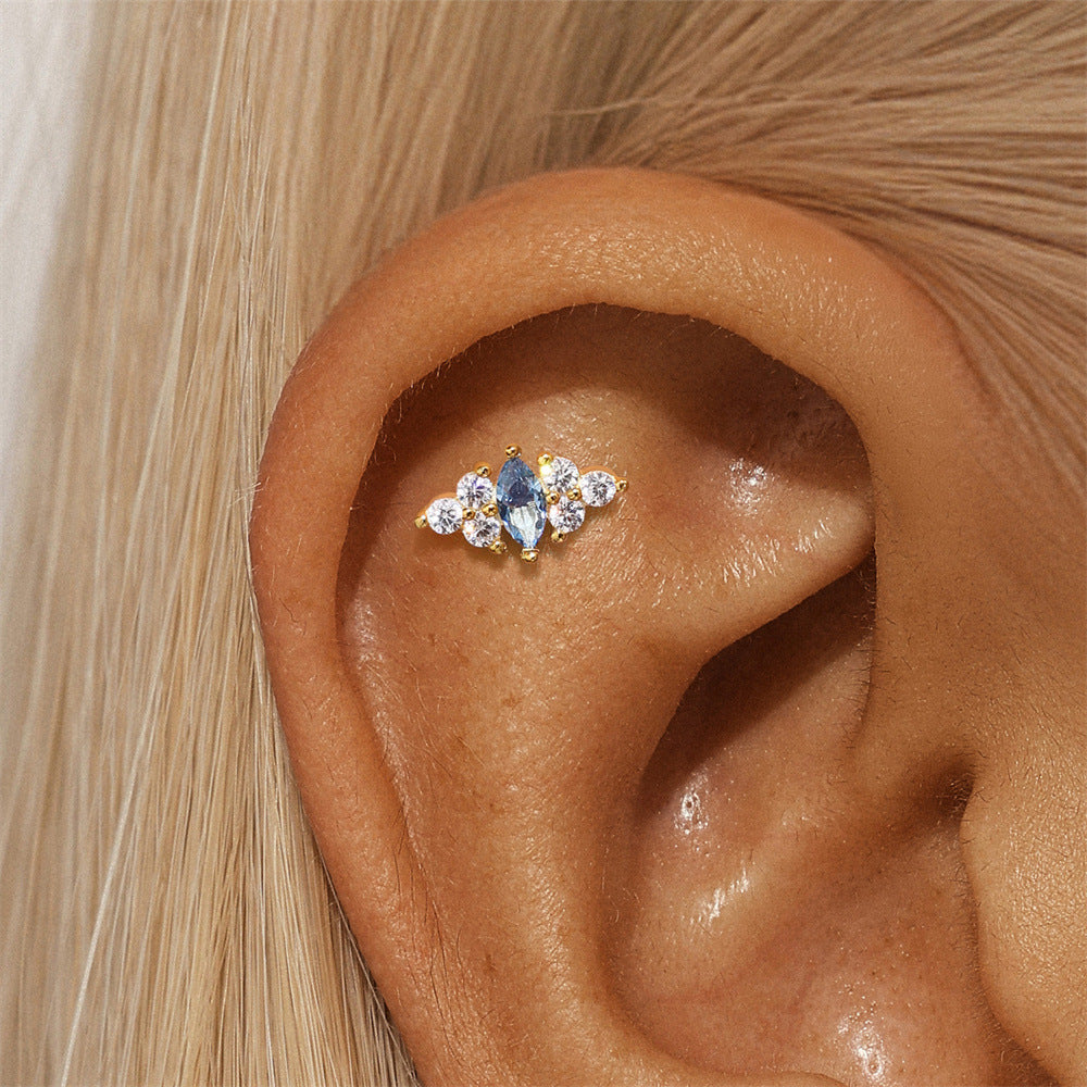 Dainty marquise-cut opal stud earring in gold, beautifully styled on ear for a chic and elegant look.