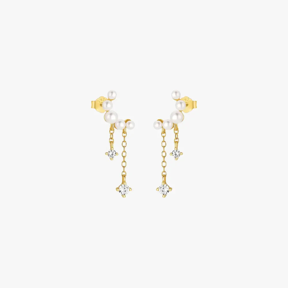 Elegant gold chain drop earrings with pearls and diamond charms for a chic and sophisticated look.