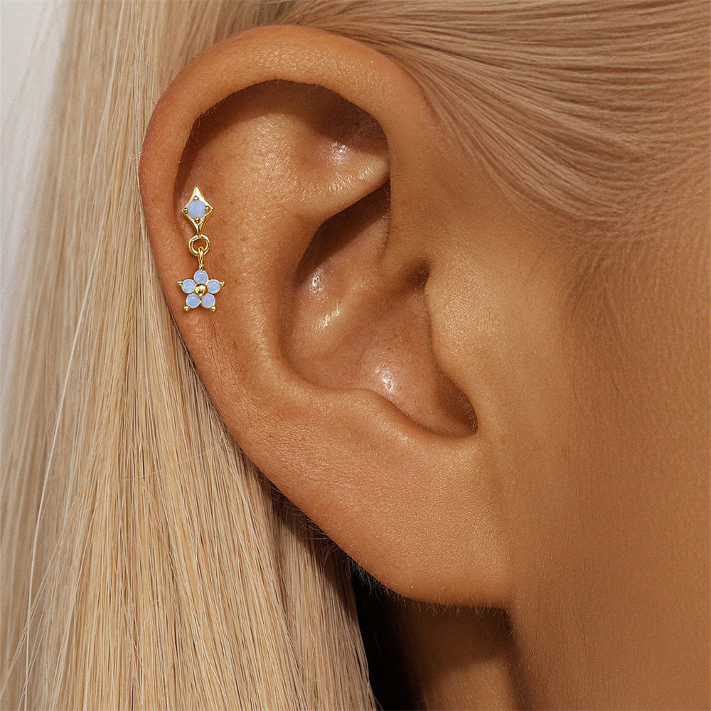 Dainty opal flower drop earrings in gold-plated sterling silver, perfect for cartilage or lobe piercings, adding a subtle sparkle.