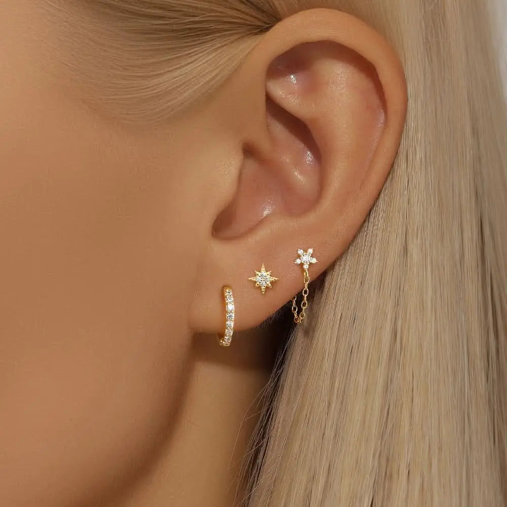 Gold star earrings with chain and diamond accent