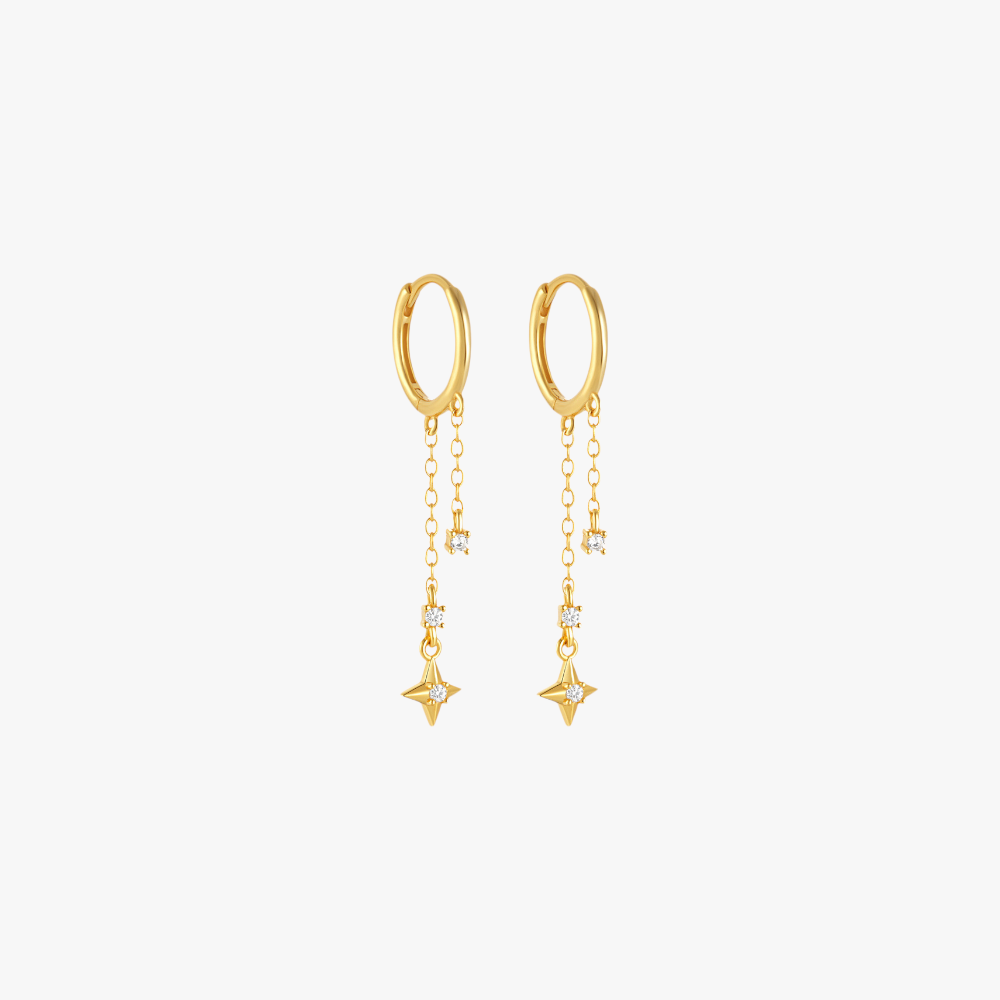 Gold star drop earrings with diamond accents, perfect for elegant and minimalist styling.