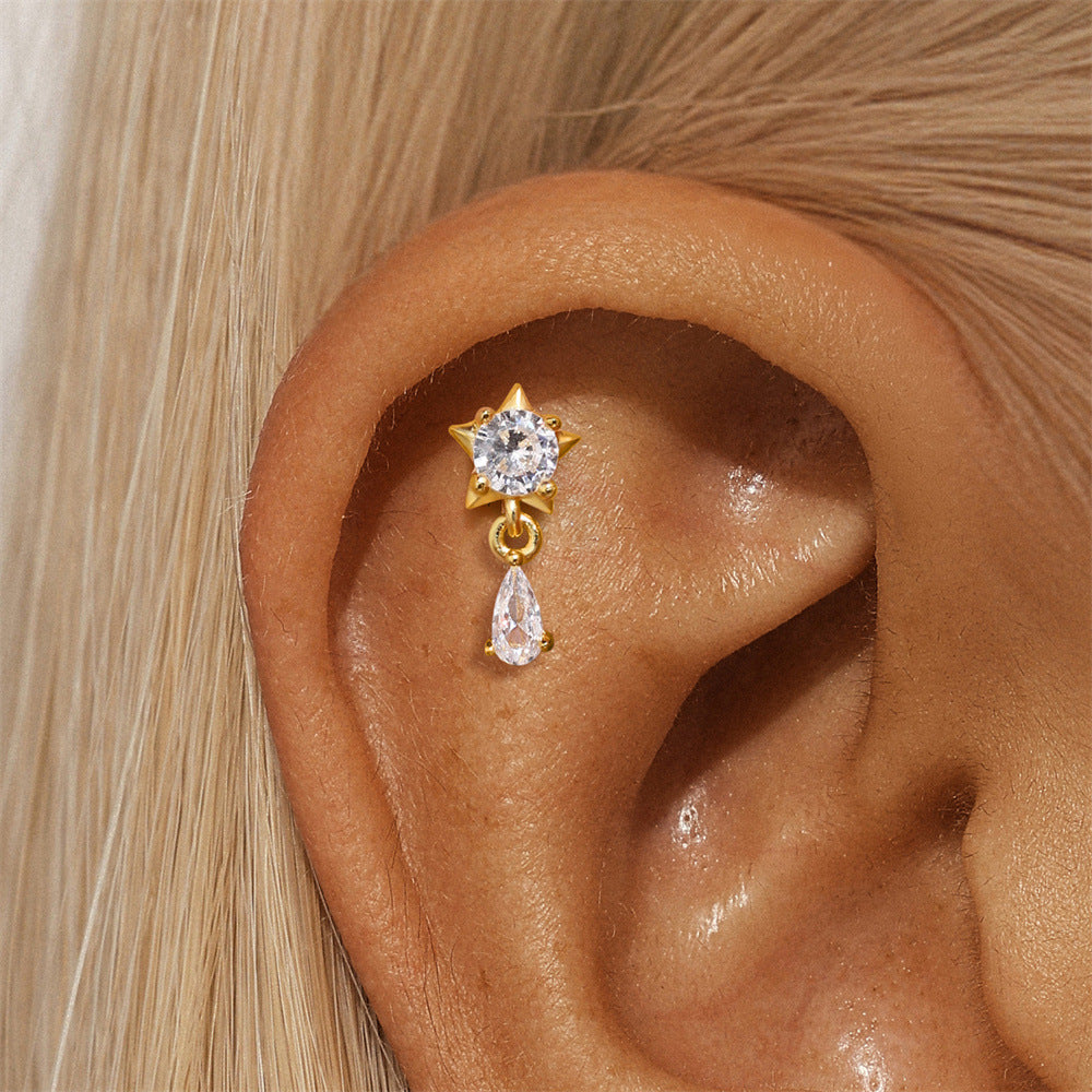 Gold zirconia star drop earrings for women. Featuring a delicate star design with a dangling teardrop cubic zirconia, these earrings add sparkle and elegance to any outfit.