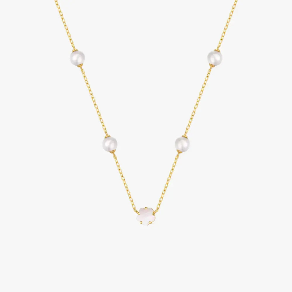 Stylish golden necklace with pearls and a white clover charm, crafted from 925 sterling silver.