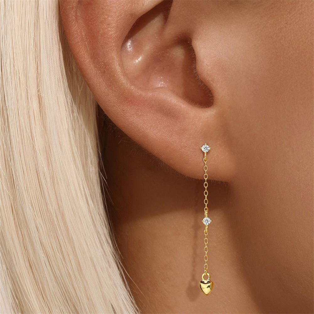 Elegant long heart chain earrings in gold, featuring zircon details. Stylish and lightweight, ideal for modern women’s fashion.
