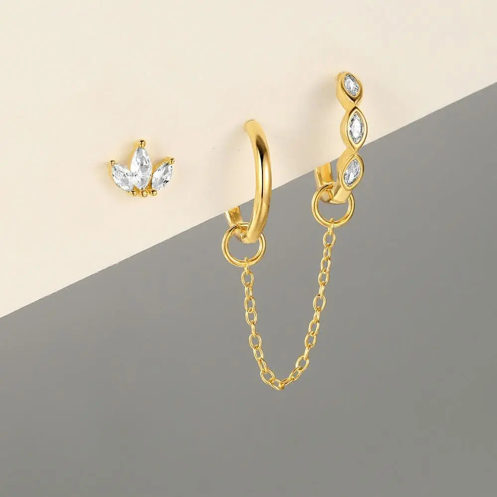 Gold huggie earrings with marquise diamonds and chain, elegant and modern earring set.