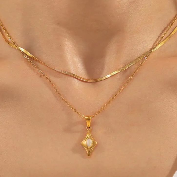 Model wearing 14k gold-plated titanium steel necklace with a cat's eye stone four-corner star pendant.