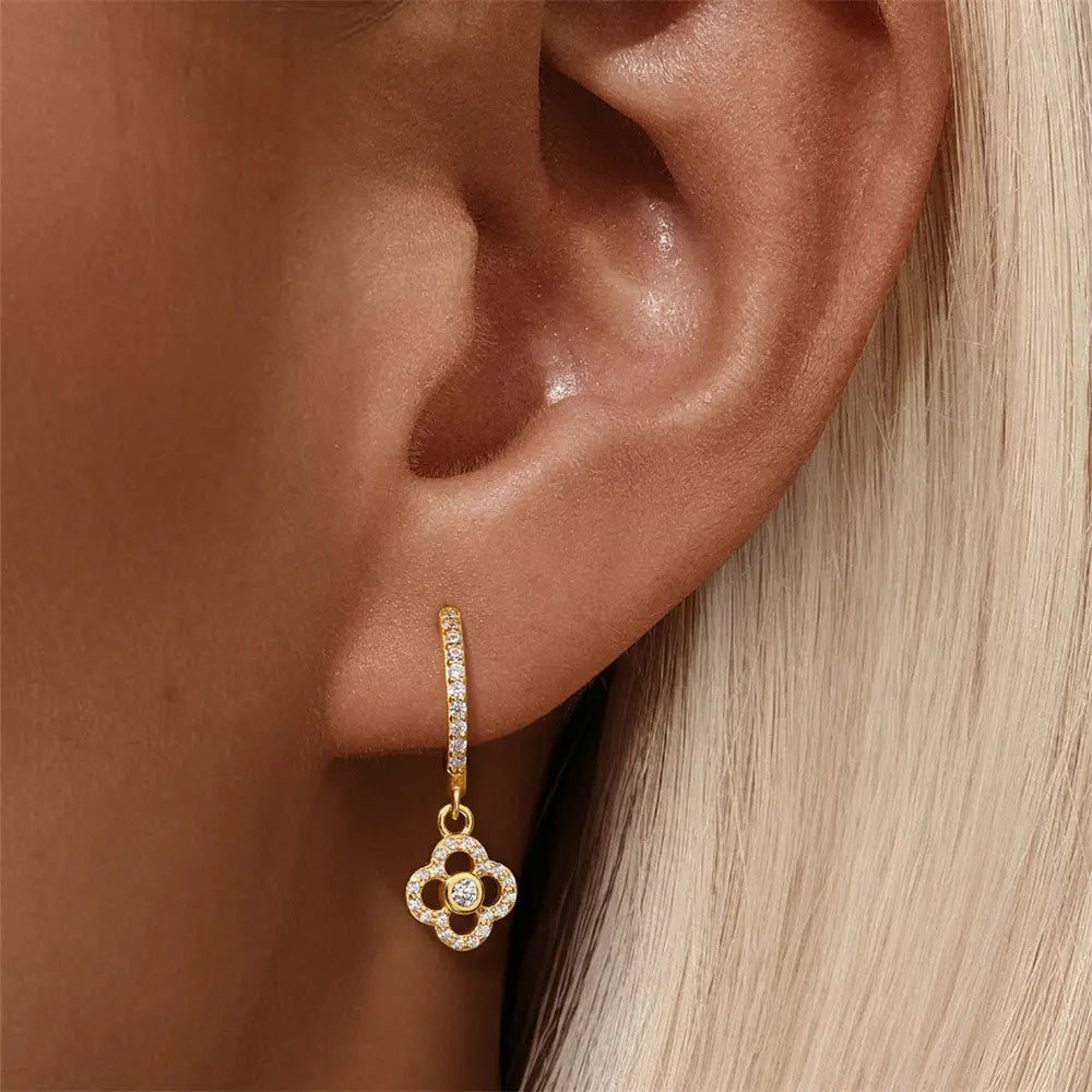  Model wearing 925 sterling silver flower zirconia dangle earrings. The perfect blend of modern elegance and charm.