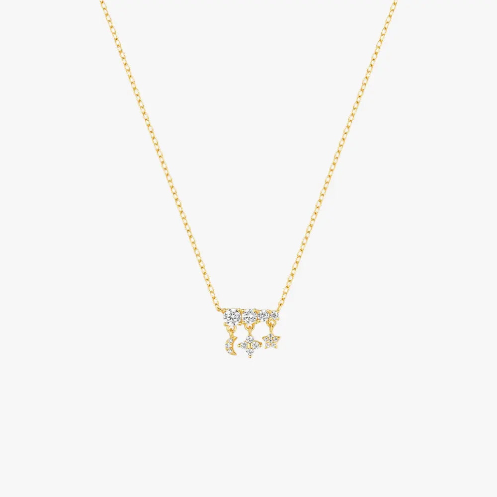 Gold necklace with moon, star, and diamond charms, celestial-inspired design.