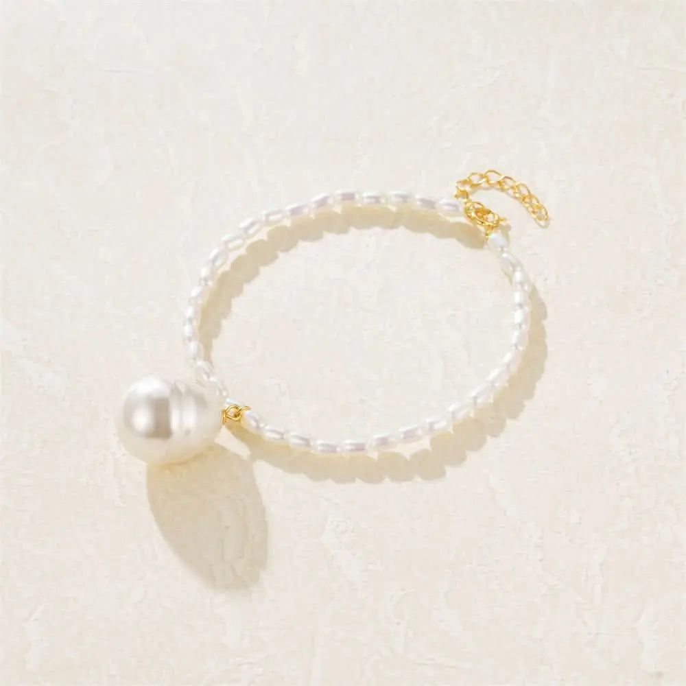 Elegant pearl bracelet featuring a large baroque pearl charm, perfect for formal and casual wear.