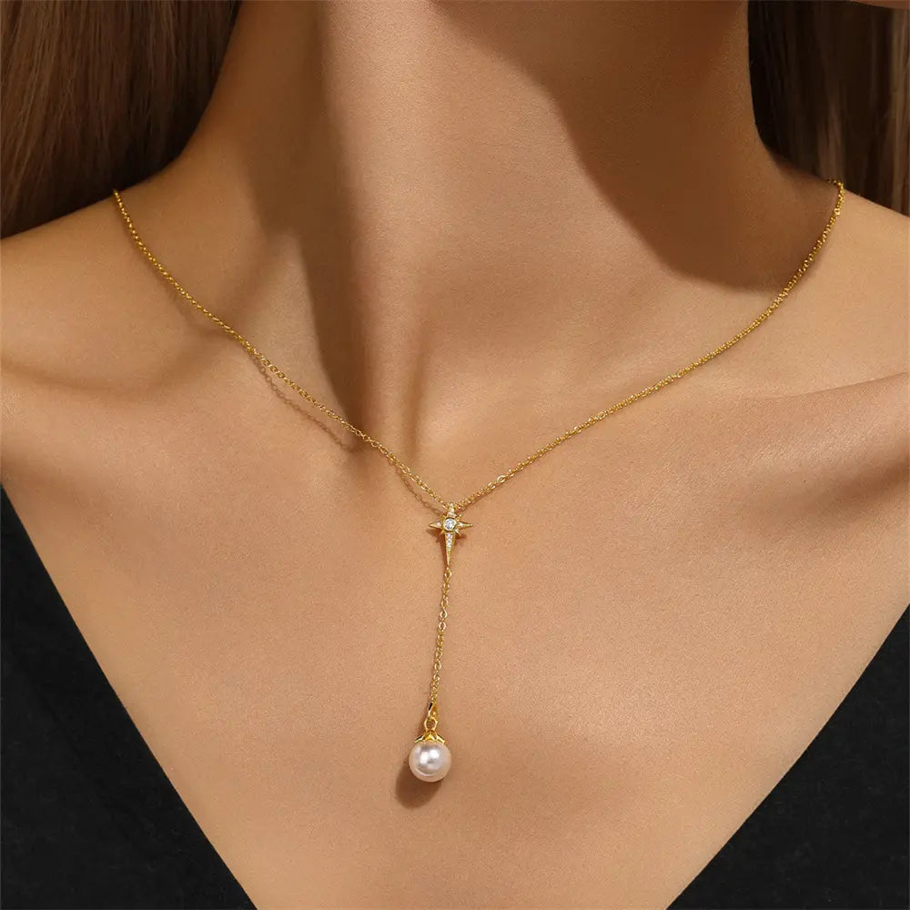 Elegant gold Y-shaped necklace with a star and pearl design, shown worn on a model's neck for a chic and graceful look.