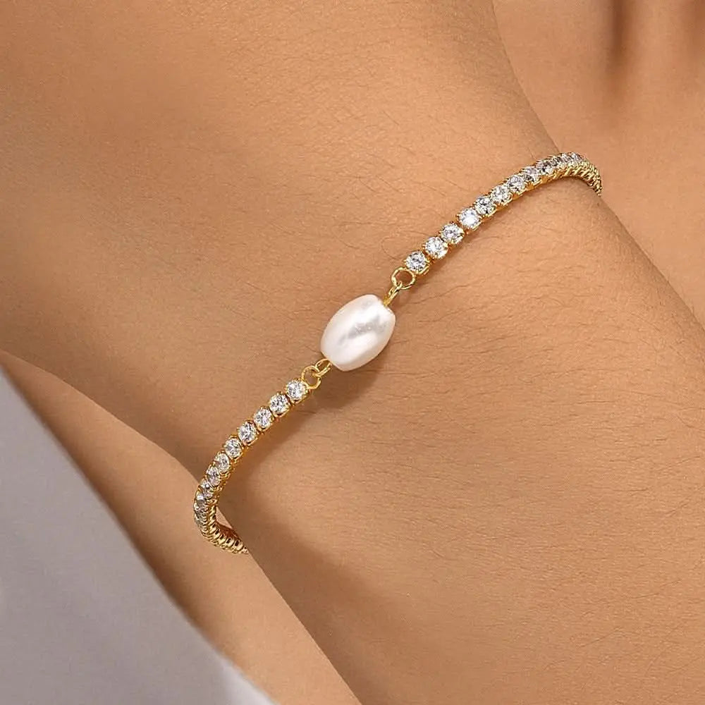  Stylish pearl drop bracelet elegantly worn on the wrist.