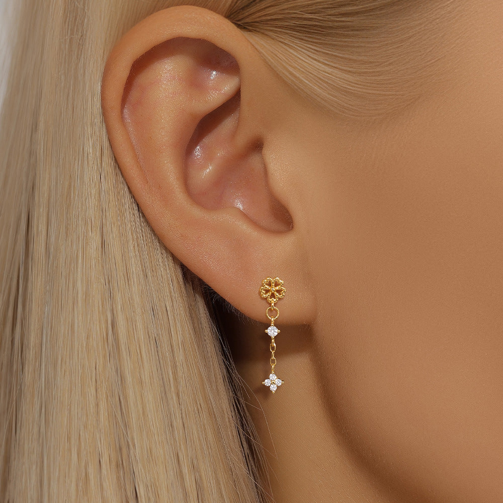 Triple star gold earrings with diamonds, worn by model, perfect for a trendy, sparkling look.