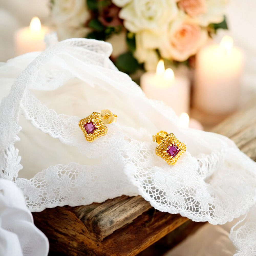 Unique diamond-shaped earrings with a striking red gemstone and crystal accents.